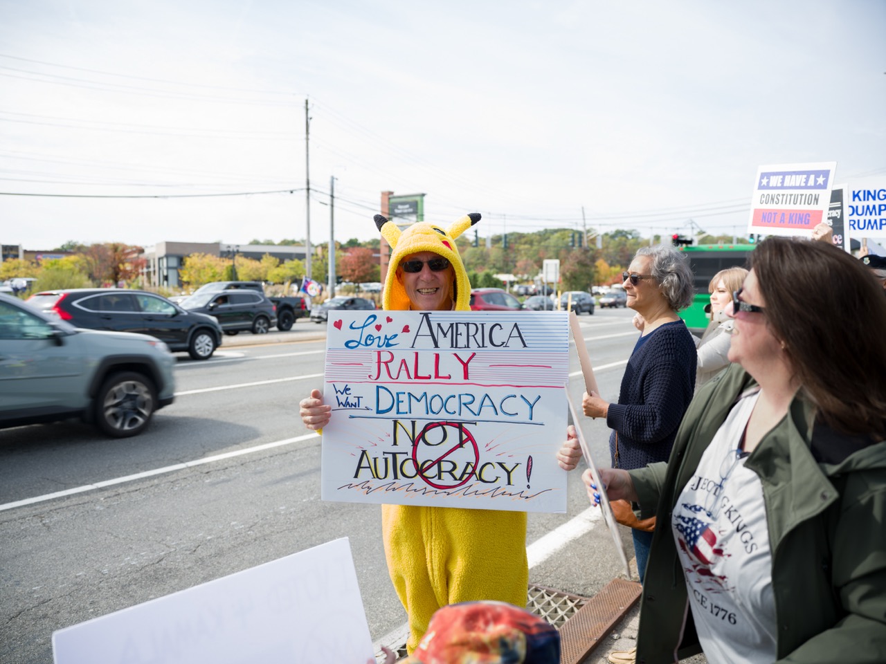 A man in a pikachu suit at a protest march