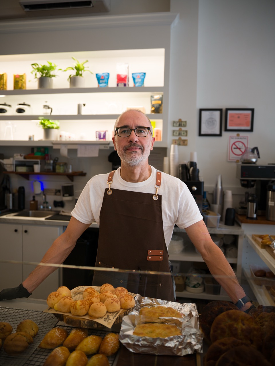 A man holding bread at a cafe