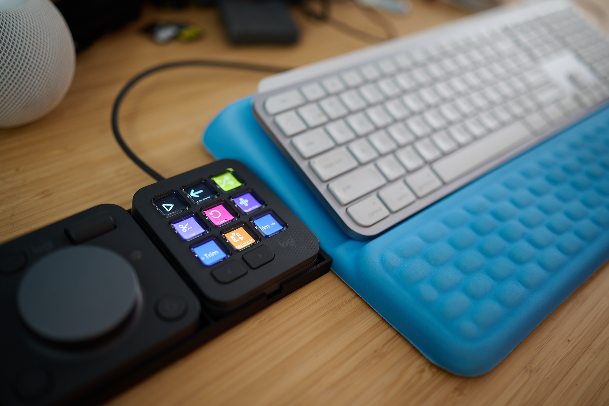 The Logitech MX Creative Console sitting next to a keyboard.