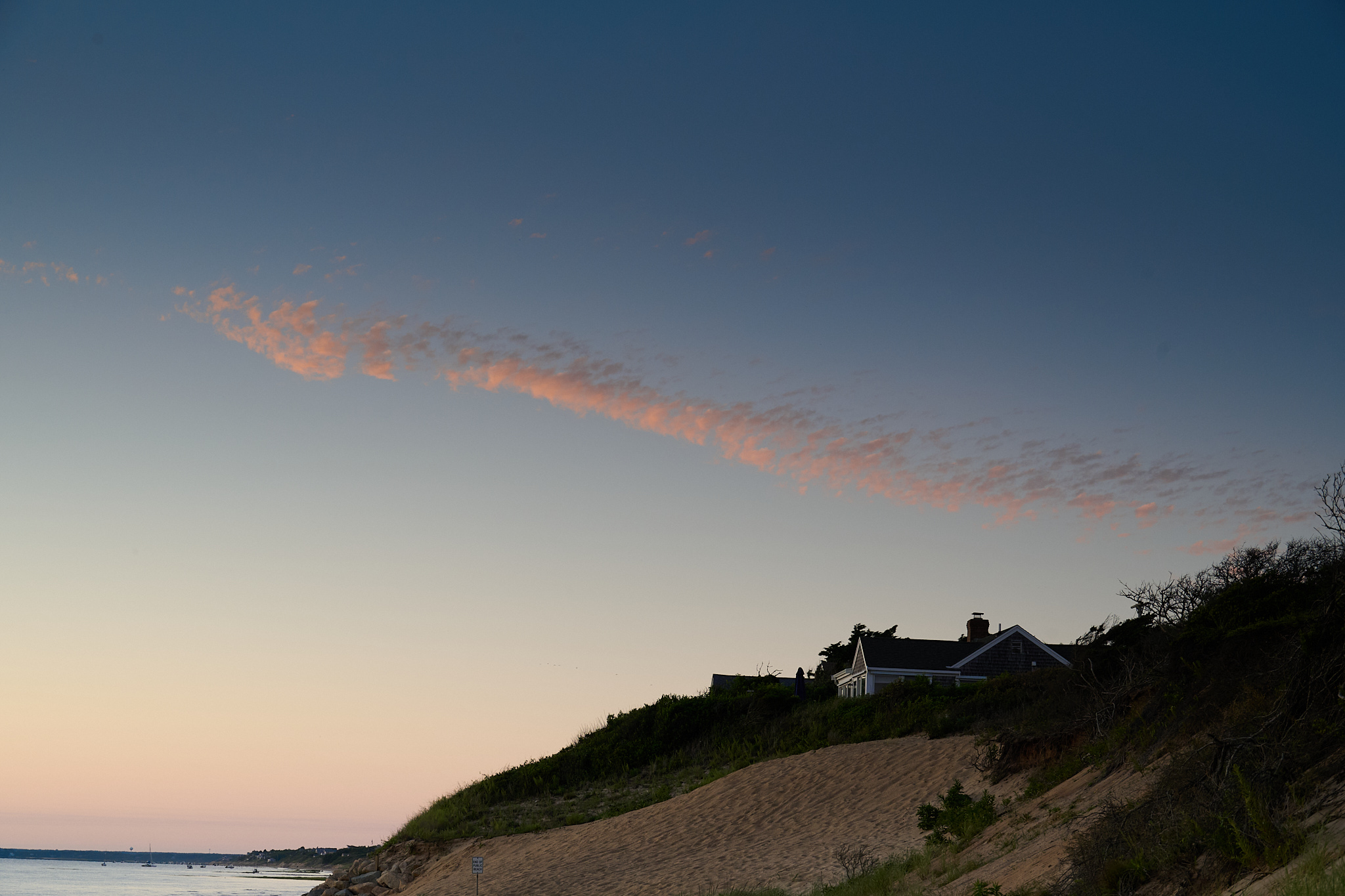 Clouds across the sky at night at the beach.