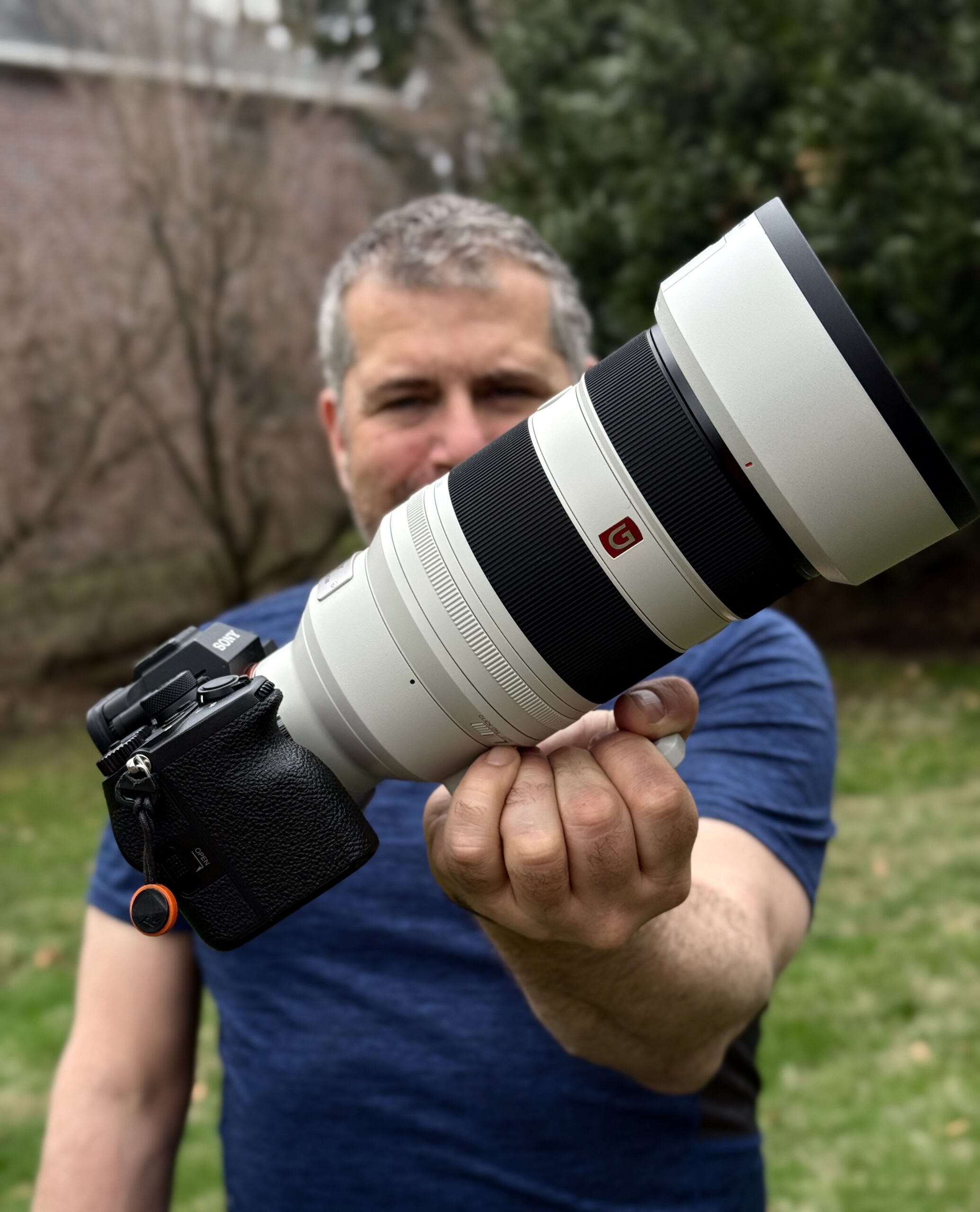 A photo of the reviewer holding the large Sony FE 50-150mm lens